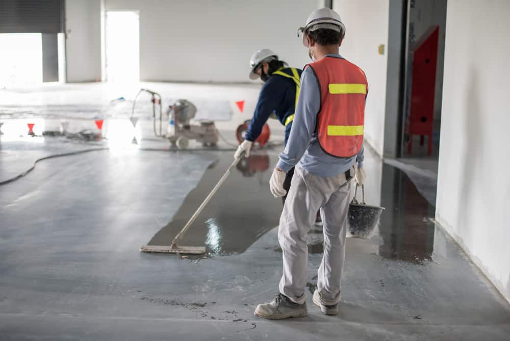 Construction Worker Painting Epoxy Flooring Or Floor Hardener