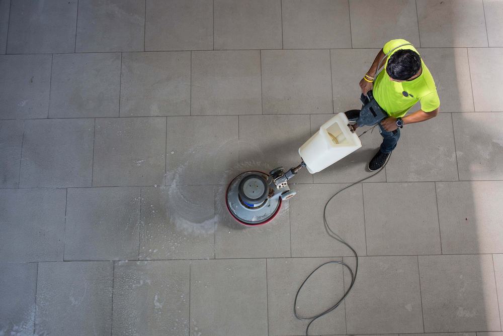 Man Cleaning Floor With Machine.